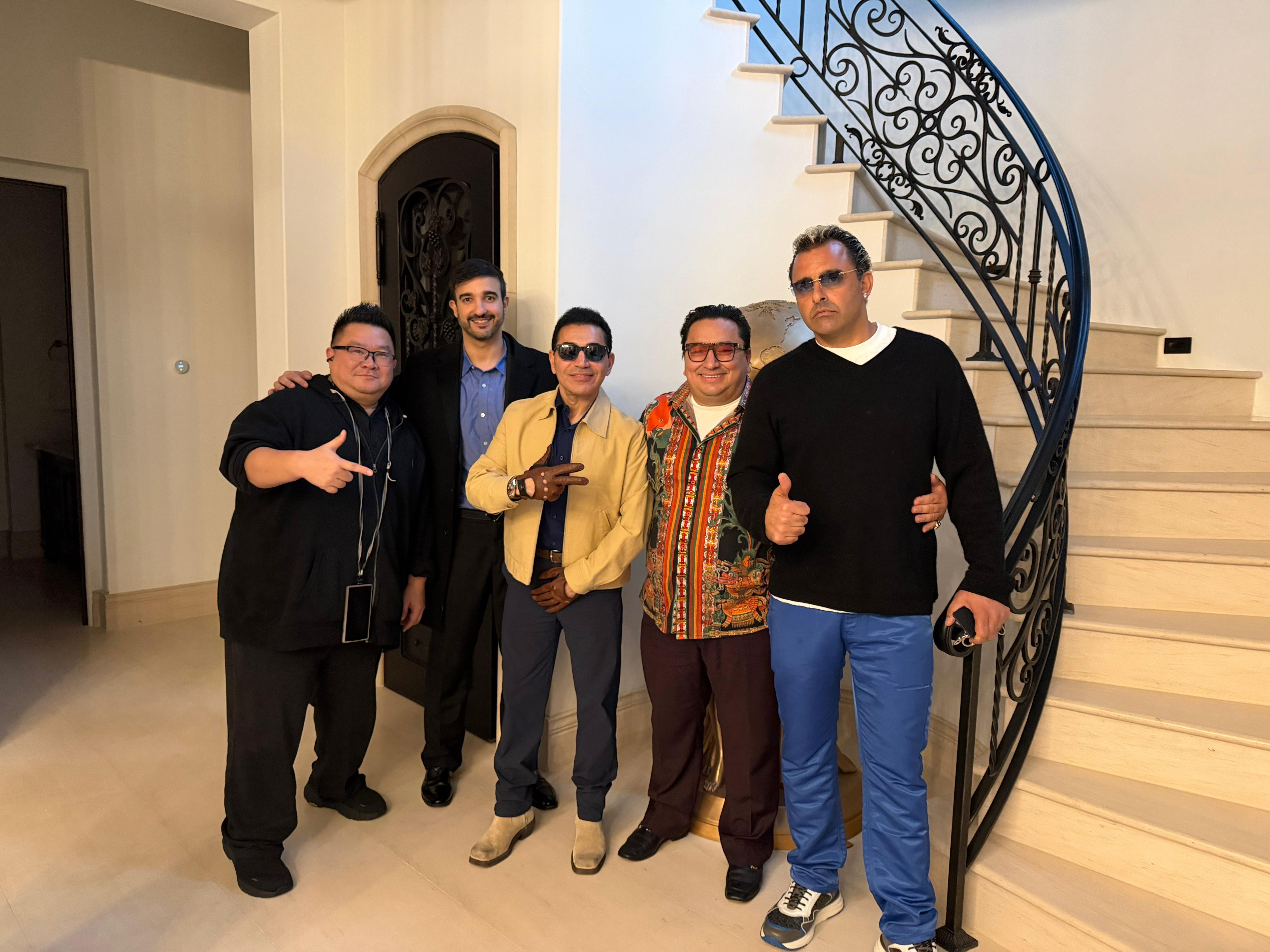 Fred Khalilian with close associates at luxury estate staircase